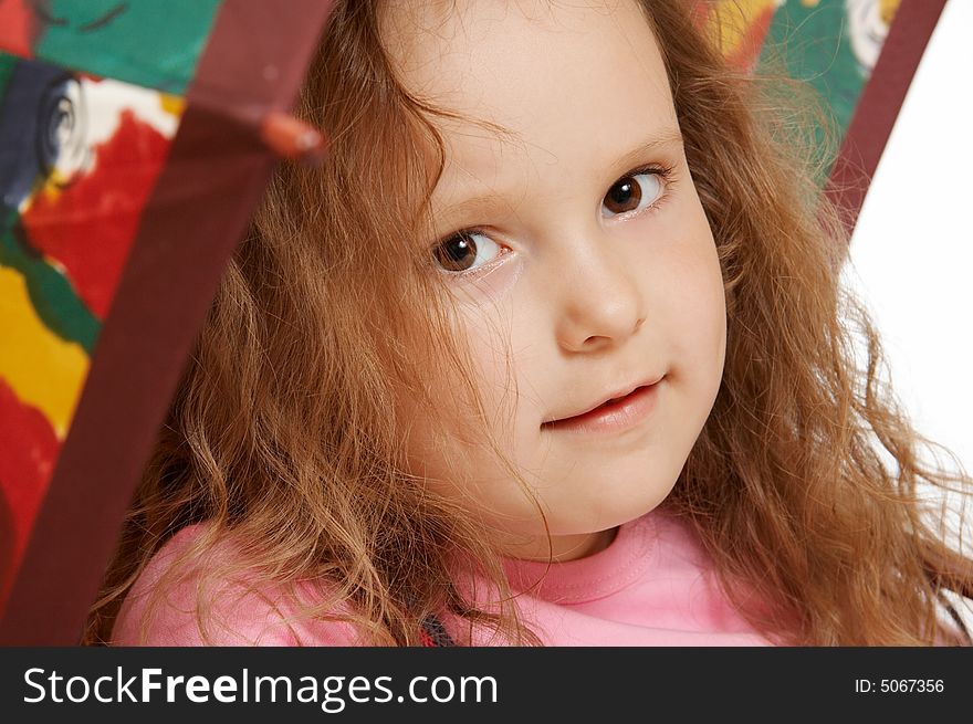 The little girl sits under an umbrella. The little girl sits under an umbrella