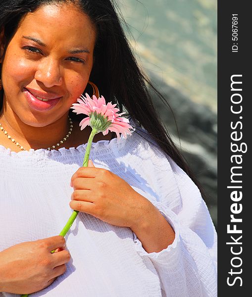 Young African American Woman holding a Pink Daisy