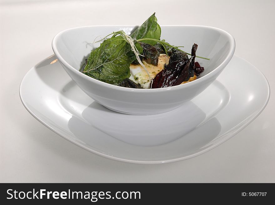Roasted goat cheese with olive leaves. Roasted goat cheese with olive leaves
