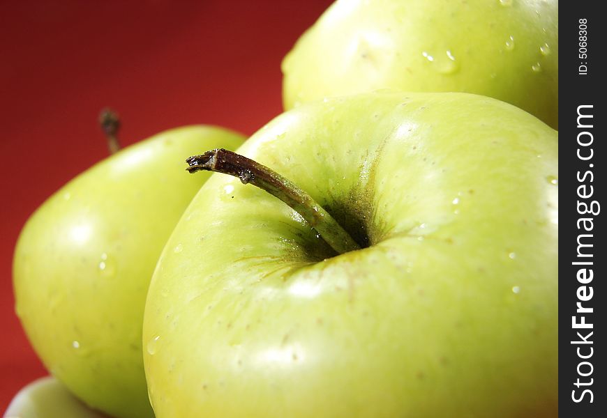 Several fresh green apples on red background. Several fresh green apples on red background