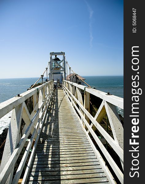 Picture of a bridge going to a light house