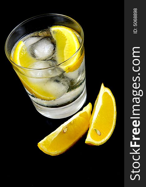 A glass of soda water with a slice of lemon. A glass of soda water with a slice of lemon