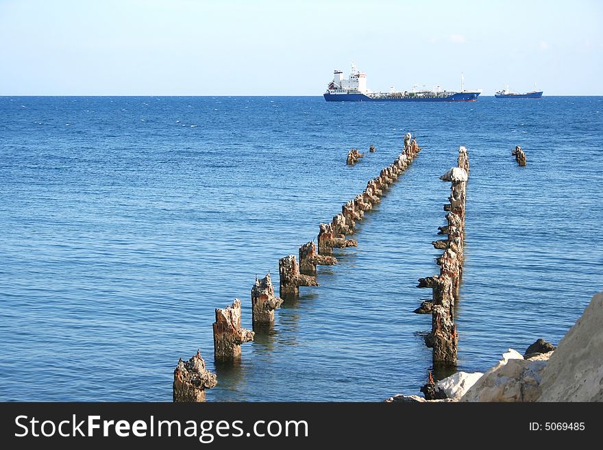 Old broken pier waits the ship. Old broken pier waits the ship.