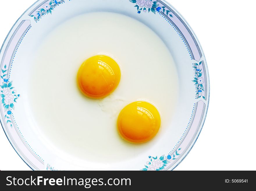 Double-yolk egg in dish.