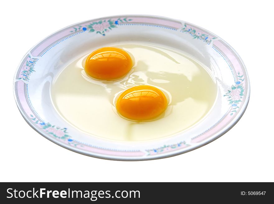 Double-yolk egg in dish.