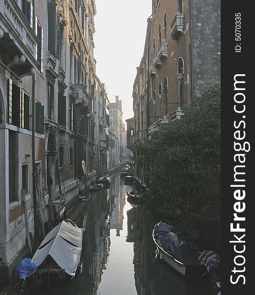 Venice (Italy) postcard: houses along a narrow back canal in Venice, dusk reflections. Venice (Italy) postcard: houses along a narrow back canal in Venice, dusk reflections
