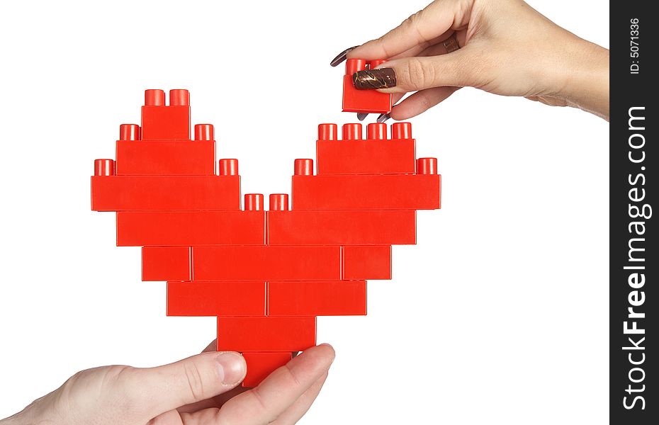 Hands building red heart isolated over white background