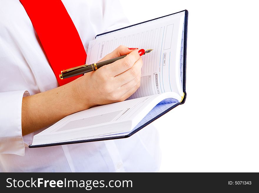 Hand of girl with pen over notebook. Hand of girl with pen over notebook