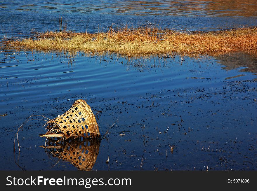 A broken boamboo raft in the lake. A broken boamboo raft in the lake.