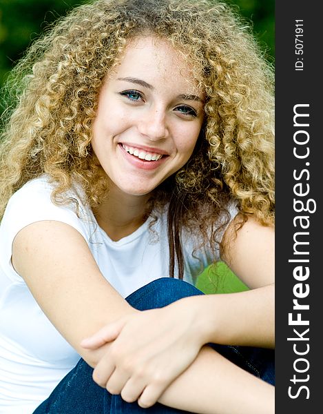 A young attractive girl sitting in the park