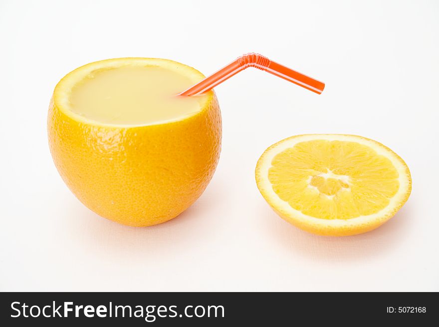Orange full of juice with straw