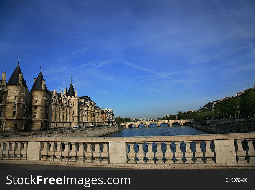 Near Notre Dame basilica in Paris, also known as Notre-Dame de Paris on spring blue sky and grenn trees. Near Notre Dame basilica in Paris, also known as Notre-Dame de Paris on spring blue sky and grenn trees.