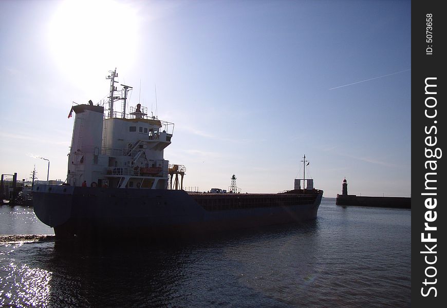 Small cargo ship leaving a port