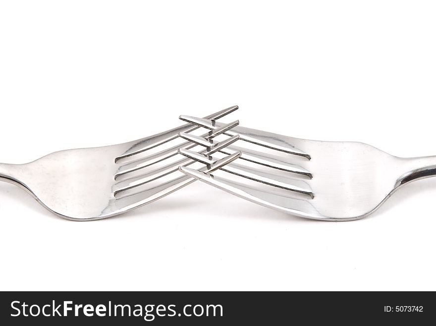 Two stainless steel forks on a white background. Two stainless steel forks on a white background.