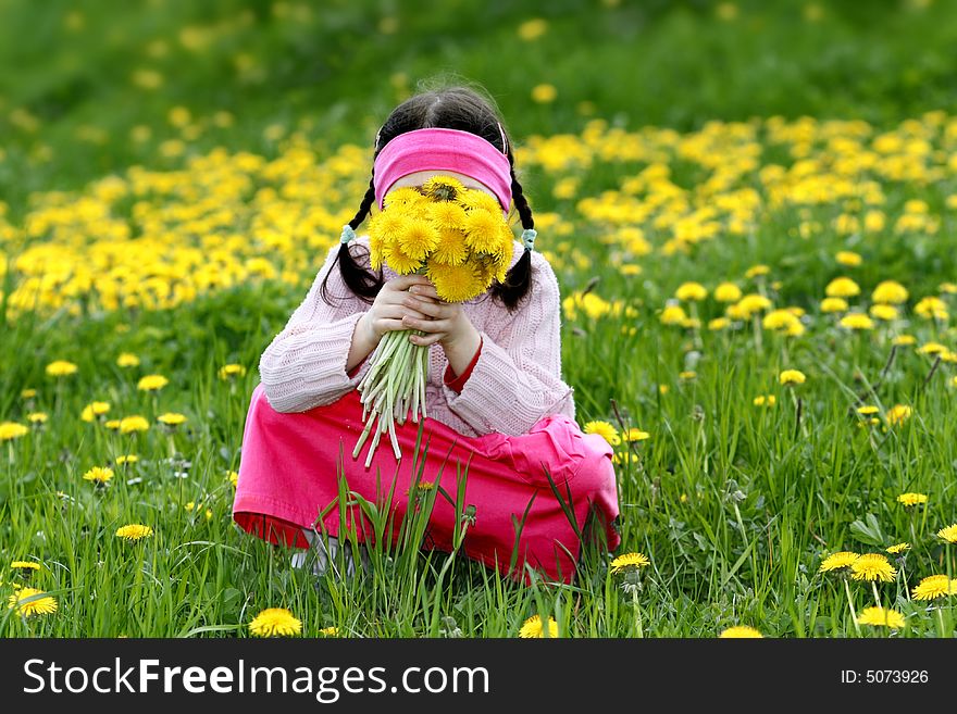 Little girl picking dandelions for mom, on Mother's day.