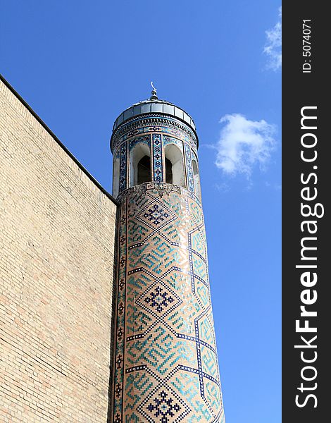 Fragment of minaret on the sky background