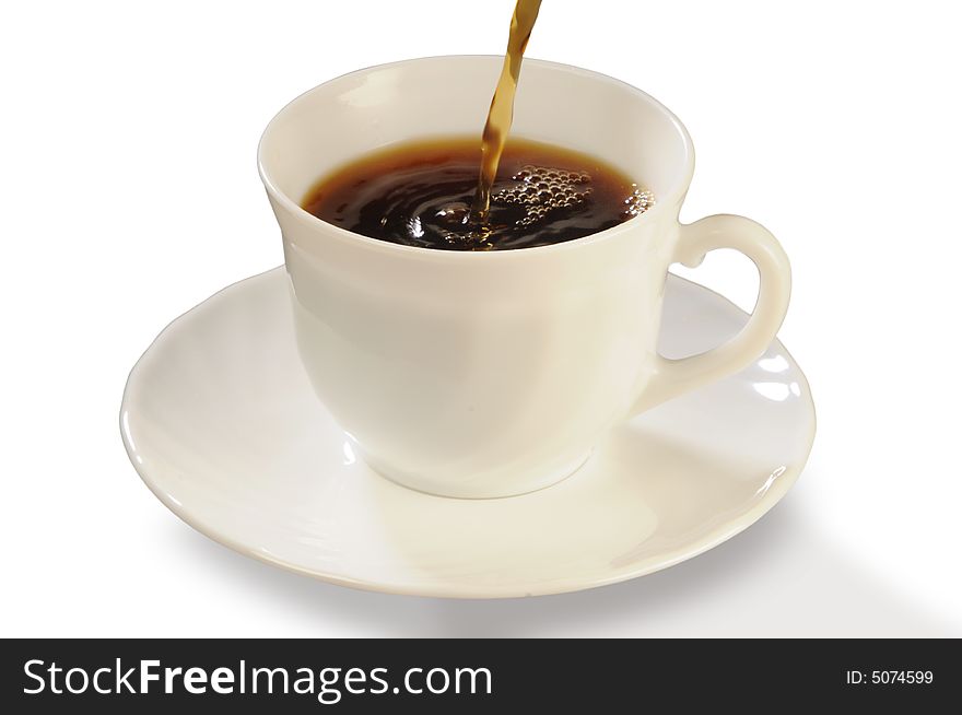 Coffee flows in a white cup on a saucer. Coffee flows in a white cup on a saucer