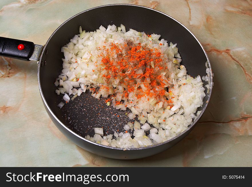 Frying onion. Stage. Minced onion with salt, black and red pepper.