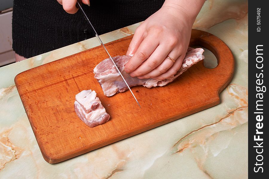 Cutting meat, bald-rib on wooden board. Cutting meat, bald-rib on wooden board.