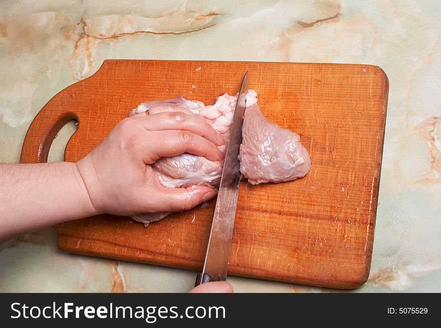Cutting meat, bald-rib on wooden board. Cutting meat, bald-rib on wooden board.