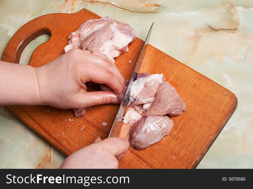 Cutting meat, bald-rib on wooden board. Cutting meat, bald-rib on wooden board.