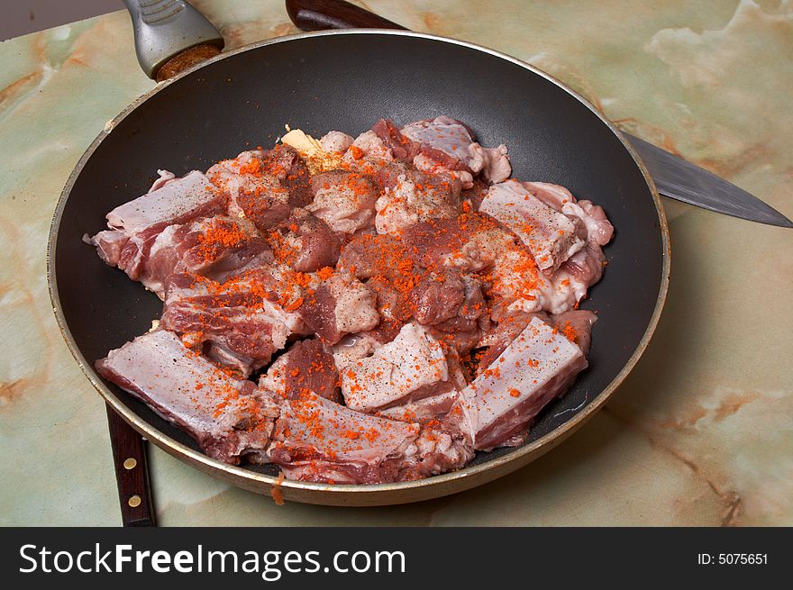 Meat pieces in frying pan with black and red pepper. Ready. Meat pieces in frying pan with black and red pepper. Ready.