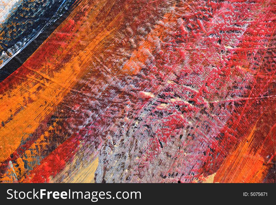 Bright orange, red, grey, and blue paint on a rough wall, a small detail from a large graffiti-style mural in Los Angeles, California. Bright orange, red, grey, and blue paint on a rough wall, a small detail from a large graffiti-style mural in Los Angeles, California.