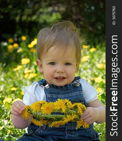 Smiling kid with garland of dandelion. Smiling kid with garland of dandelion