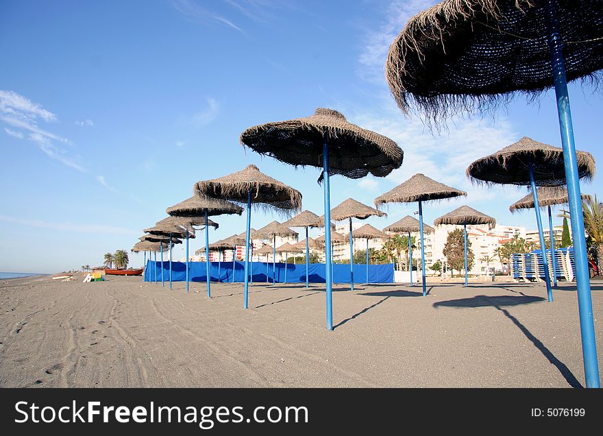 Overview of a beach with thatched umbrellas