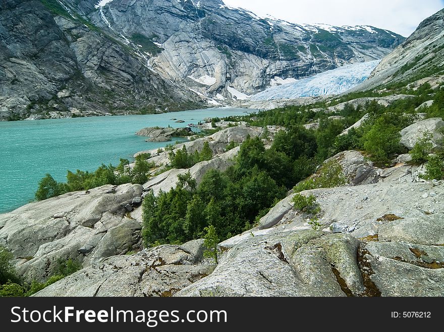 Wide angle image of a spectacular glacier flow melting into a beautiful lake. Wide angle image of a spectacular glacier flow melting into a beautiful lake