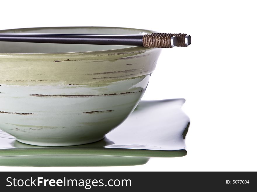 Hand painted bowl with chopsticks lying across. Slightly back lit. Hand painted bowl with chopsticks lying across. Slightly back lit.