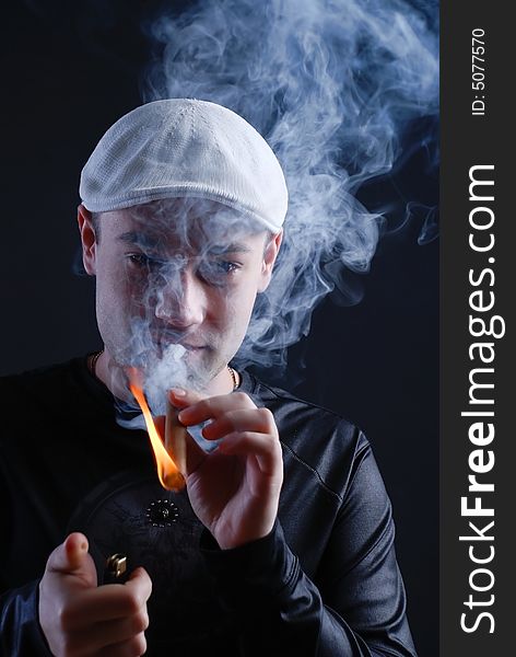 Man with cigare at black background