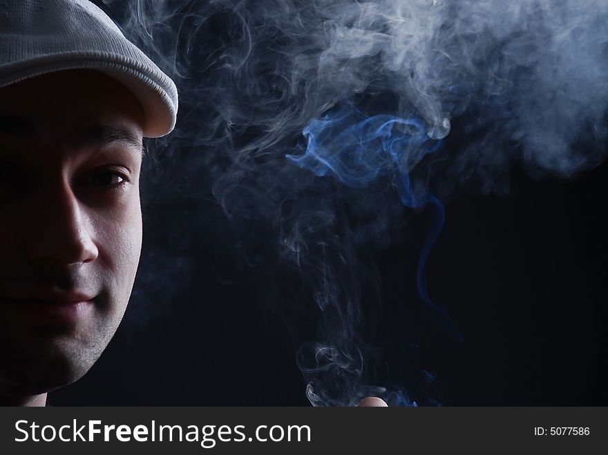 Man with cigare at black background