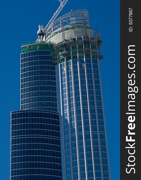 Tall Building nears completion with blue sky. Tall Building nears completion with blue sky