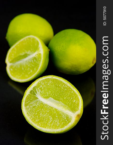 Lemon and lime fruit isolated against a black background. Lemon and lime fruit isolated against a black background