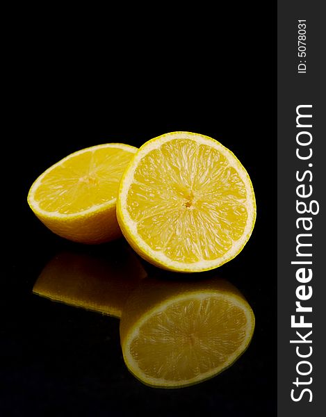 Lemon and lime fruit isolated against a black background. Lemon and lime fruit isolated against a black background