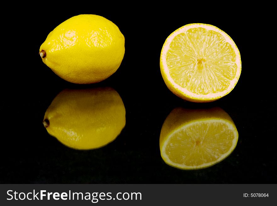 Lemon and lime fruit isolated against a black background. Lemon and lime fruit isolated against a black background