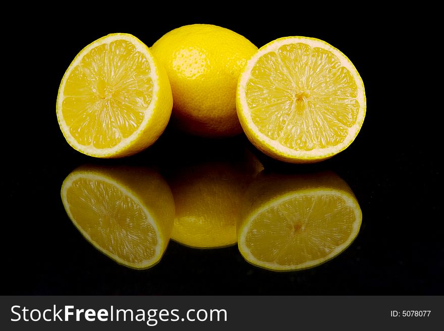 Lemon and lime fruit isolated against a black background. Lemon and lime fruit isolated against a black background
