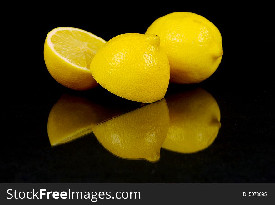 Lemon and lime fruit isolated against a black background. Lemon and lime fruit isolated against a black background