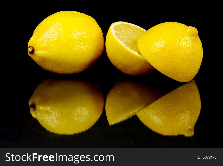 Lemon and lime fruit isolated against a black background. Lemon and lime fruit isolated against a black background