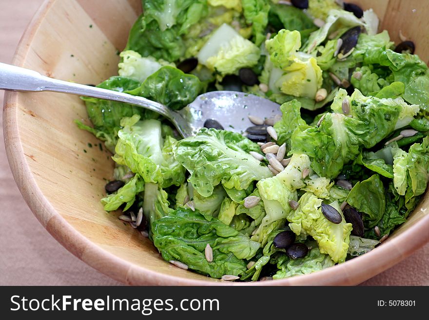 A fresh salad of saladhearts in wooden table-ware