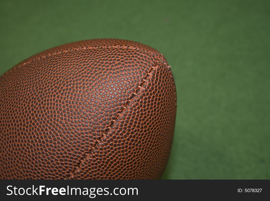 Football in close up and a green background
