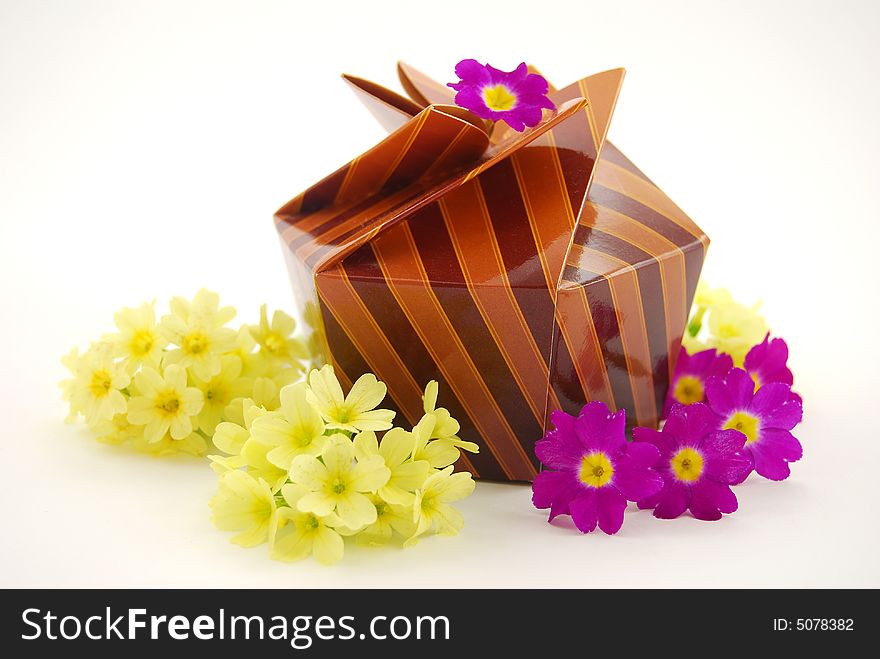 Present with spring flowers on white background