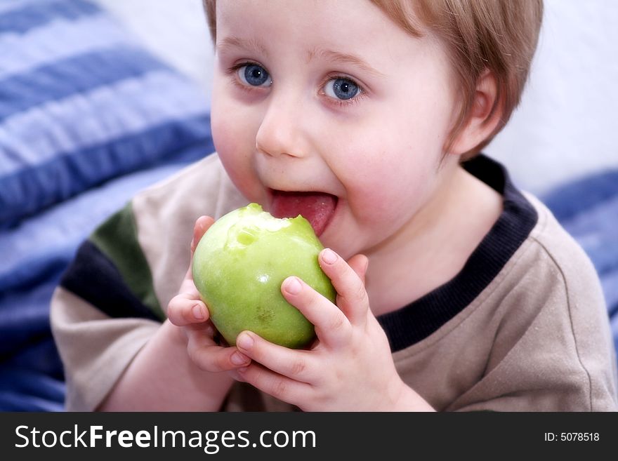 A little sweet boy with an apple