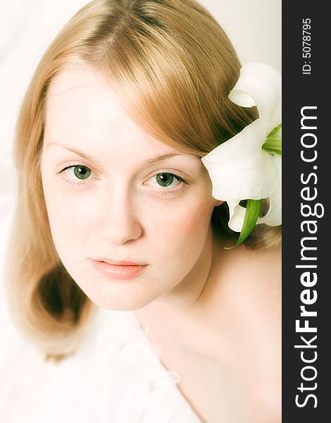 Romantic image of a young woman with white lily