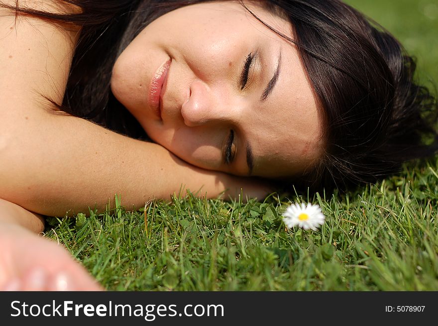 Attractive brunette woman on green grass. Attractive brunette woman on green grass