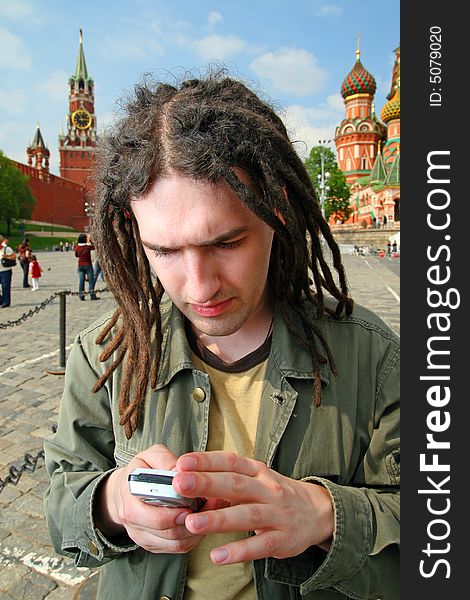 Young man with dreadlock hair and mobile phone. Young man with dreadlock hair and mobile phone.