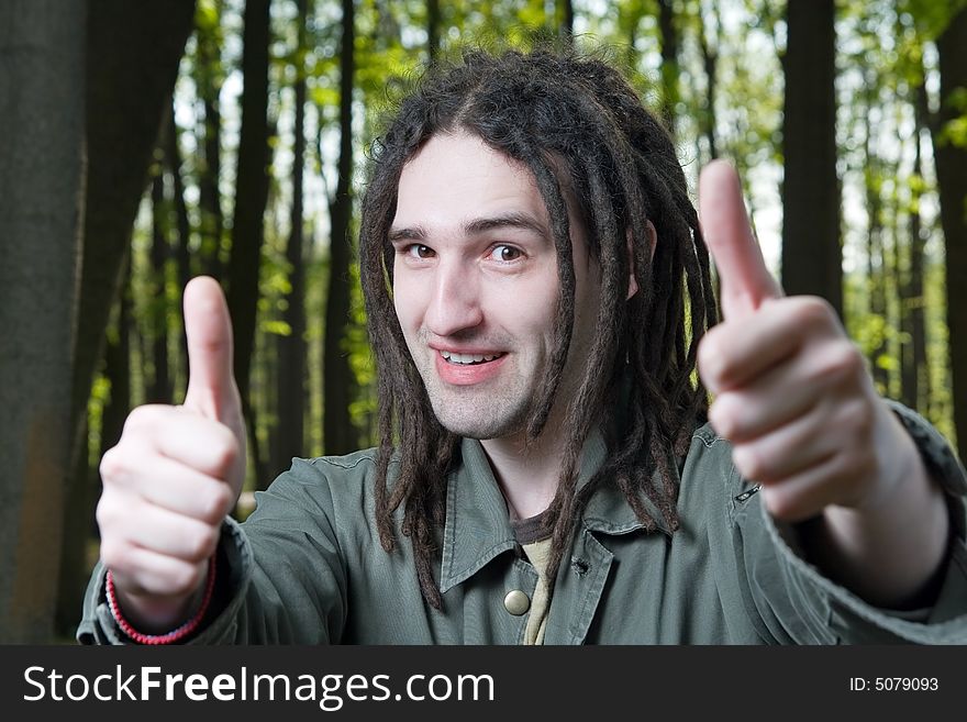 Young man with dreadlock hair gesticulates hands. Young man with dreadlock hair gesticulates hands.