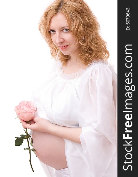 Romantic image of beautiful pregnant woman with rose in her hand over white