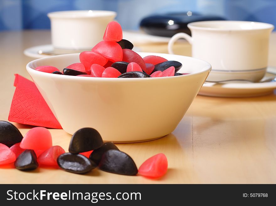 Candy with coffee cups in the background. Candy with coffee cups in the background